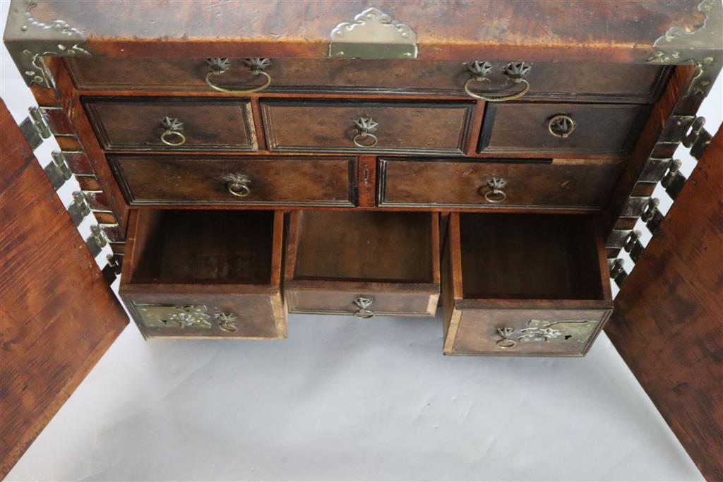 An Indo-Dutch satinwood and brass mounted cabinet, Batavia 1650-1680, Width 2ft 4in, depth 1ft 7in, height 2ft.